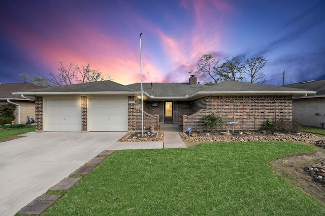 ranch-style house with an attached garage, a lawn, brick siding, and driveway