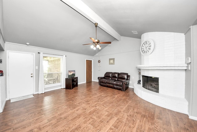 unfurnished living room with wood finished floors, a fireplace, baseboards, ceiling fan, and vaulted ceiling with beams