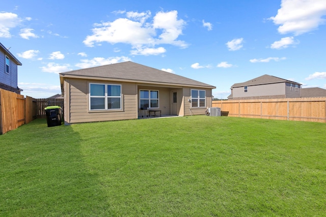 back of house featuring a yard, a fenced backyard, and cooling unit