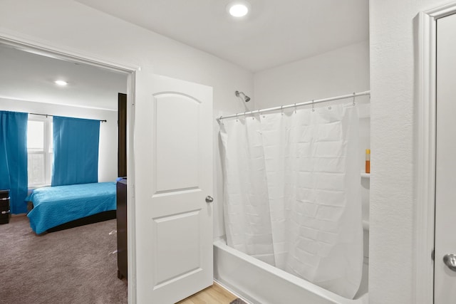 ensuite bathroom featuring recessed lighting, connected bathroom, and shower / bath combo