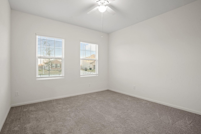 unfurnished room featuring a ceiling fan, carpet, and baseboards