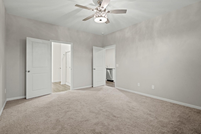 unfurnished bedroom with a ceiling fan, baseboards, and light carpet