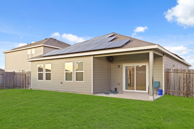 back of house featuring a patio, a lawn, and a fenced backyard