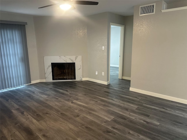 unfurnished living room with visible vents, baseboards, a ceiling fan, and dark wood-style flooring