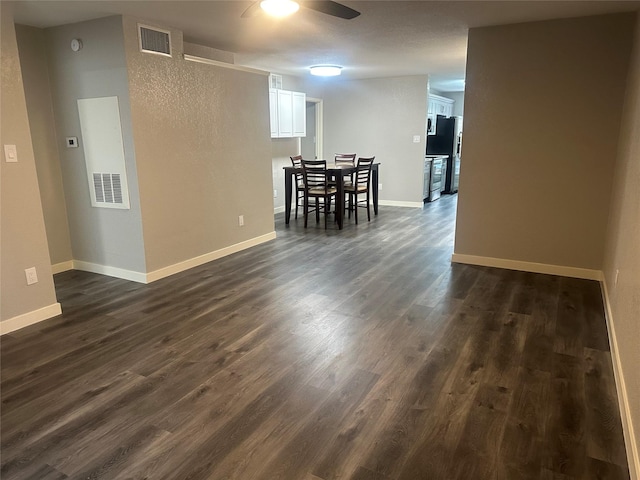 dining space featuring dark wood finished floors, visible vents, baseboards, and ceiling fan