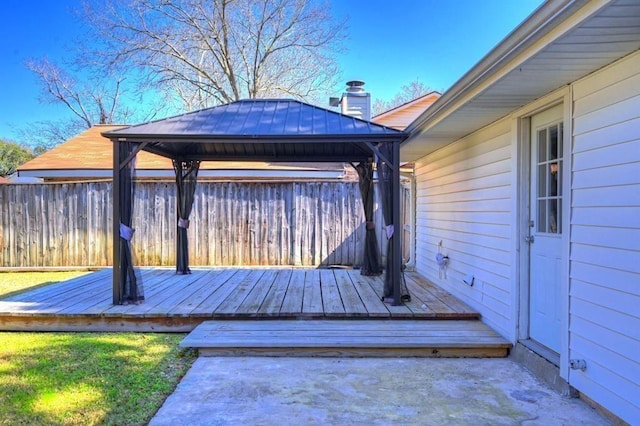 wooden deck featuring a gazebo and fence