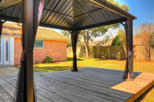 deck with a gazebo, fence, and a lawn