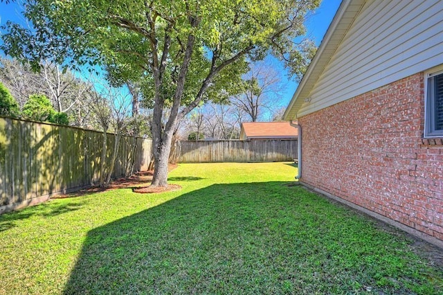 view of yard with a fenced backyard