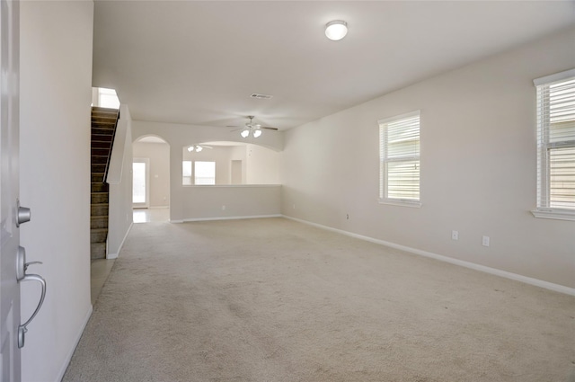 spare room featuring visible vents, baseboards, light colored carpet, and ceiling fan