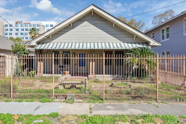 view of front of property featuring covered porch and fence