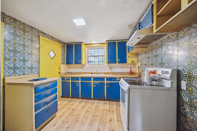 kitchen with wallpapered walls, blue cabinets, under cabinet range hood, and white range with electric cooktop