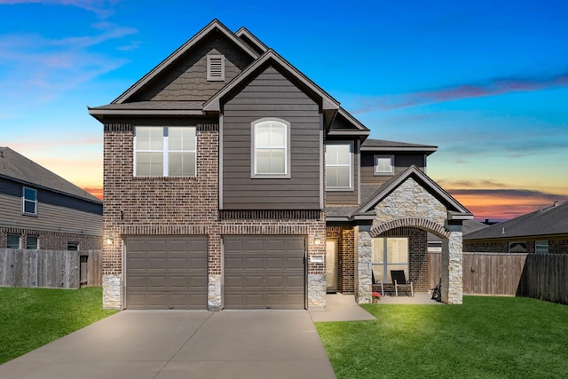 view of front of property featuring stone siding, concrete driveway, a garage, and fence