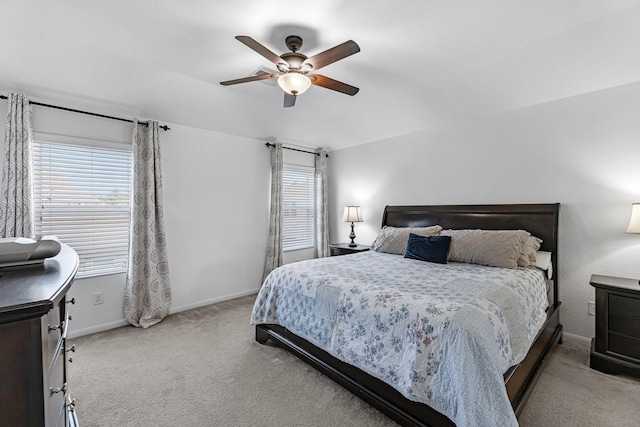 bedroom featuring carpet flooring, multiple windows, baseboards, and ceiling fan