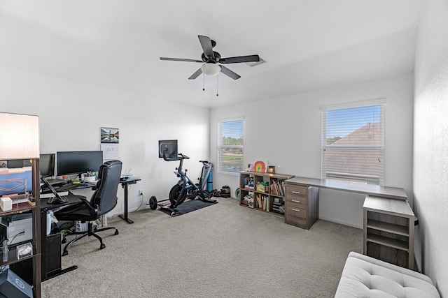 carpeted home office featuring a ceiling fan