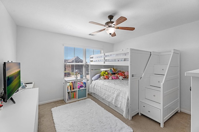 bedroom featuring light carpet, visible vents, ceiling fan, and baseboards