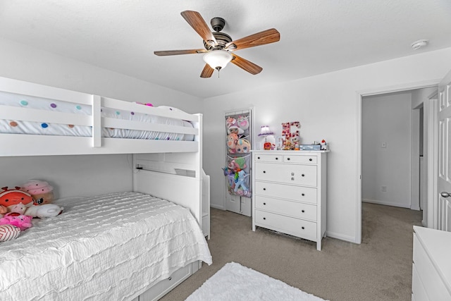 bedroom featuring ceiling fan and light carpet