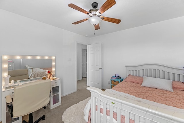 carpeted bedroom with a ceiling fan and baseboards