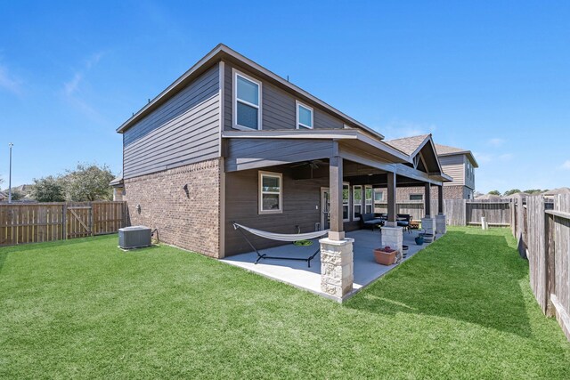 back of house featuring a patio, central AC, a fenced backyard, a yard, and brick siding