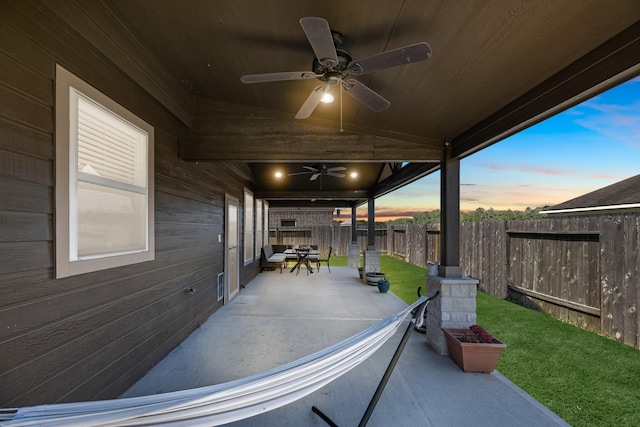 view of patio / terrace with ceiling fan and fence