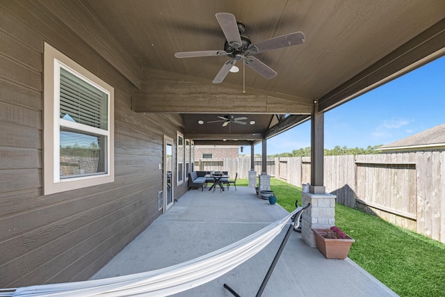 view of patio featuring fence and ceiling fan