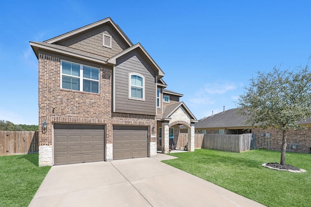 traditional-style house with a front lawn, fence, concrete driveway, a garage, and brick siding