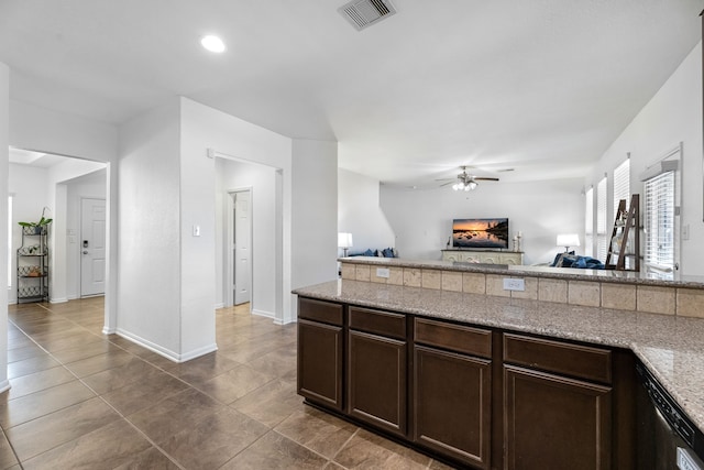 kitchen with a ceiling fan, visible vents, baseboards, dark brown cabinets, and open floor plan