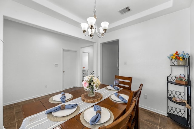 dining room with a tray ceiling, a notable chandelier, baseboards, and visible vents