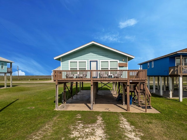 rear view of property featuring a carport, a deck, a yard, and dirt driveway