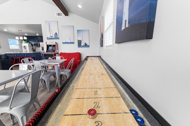 interior space featuring visible vents, vaulted ceiling with beams, baseboards, recessed lighting, and wood finished floors