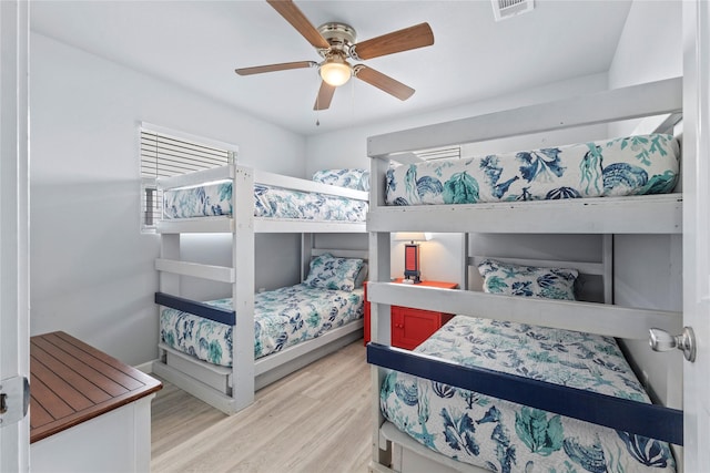 bedroom with visible vents, a ceiling fan, and light wood finished floors