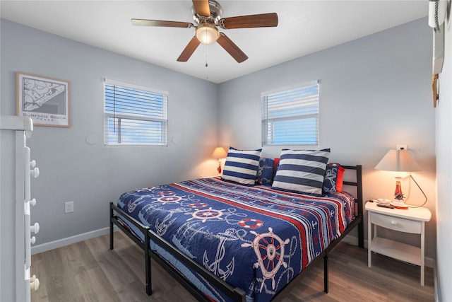 bedroom with ceiling fan, baseboards, and wood finished floors