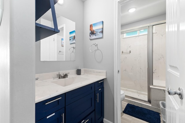 bathroom with a marble finish shower, toilet, and vanity