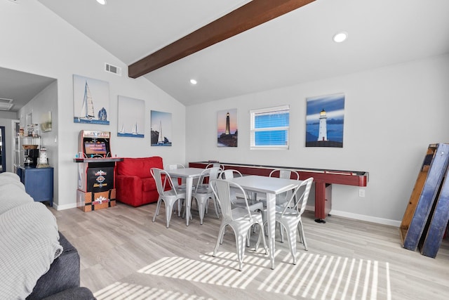 dining space featuring visible vents, baseboards, wood finished floors, and vaulted ceiling with beams