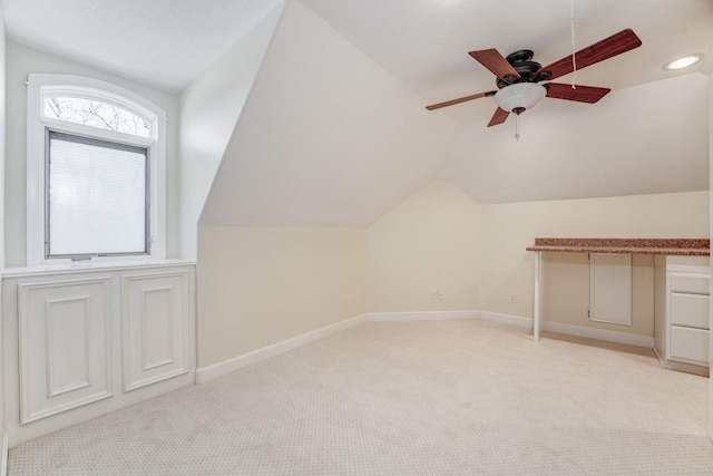 bonus room with baseboards, light carpet, a ceiling fan, and vaulted ceiling