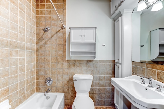 full bath with vanity, a wainscoted wall,  shower combination, tile walls, and toilet