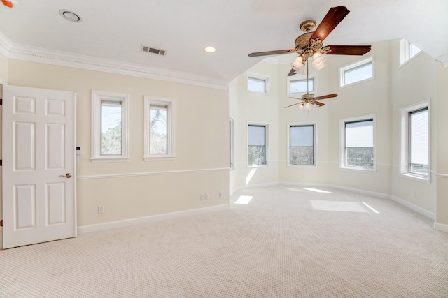 empty room featuring visible vents, a healthy amount of sunlight, ceiling fan, and carpet floors