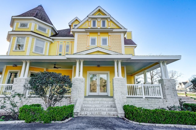 view of front of house with covered porch and french doors