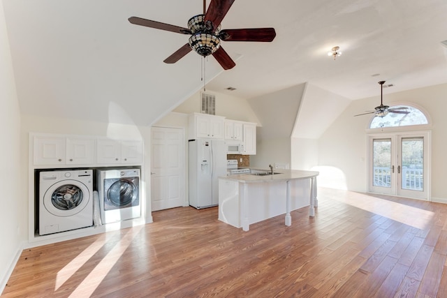 kitchen with light wood-style flooring, a ceiling fan, a sink, white appliances, and washing machine and clothes dryer