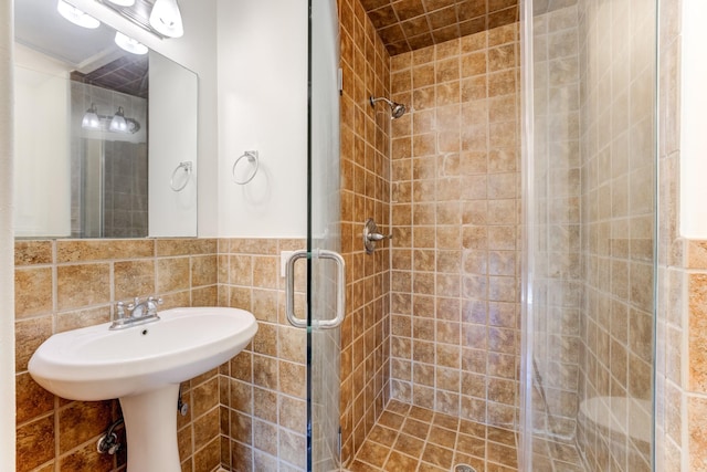 bathroom featuring tile walls and a stall shower