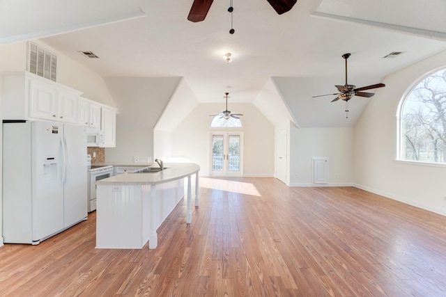 kitchen with a wealth of natural light, white appliances, and a ceiling fan