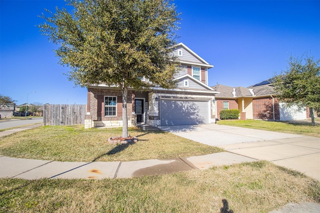 traditional-style house with brick siding, a garage, concrete driveway, and a front yard