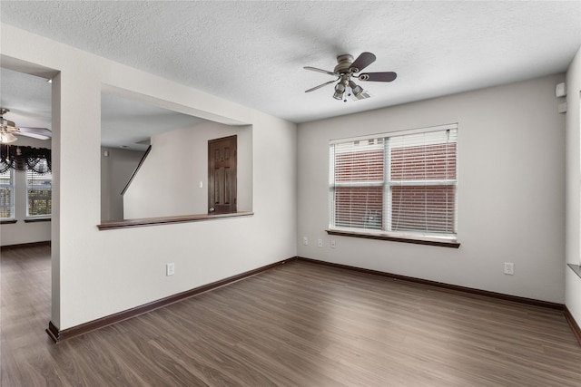 unfurnished room featuring baseboards, wood finished floors, a healthy amount of sunlight, and ceiling fan