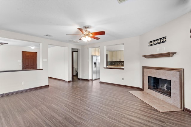 unfurnished living room featuring visible vents, ceiling fan, and wood finished floors