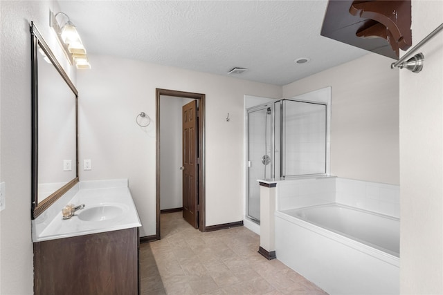 full bath with baseboards, vanity, a garden tub, a stall shower, and a textured ceiling