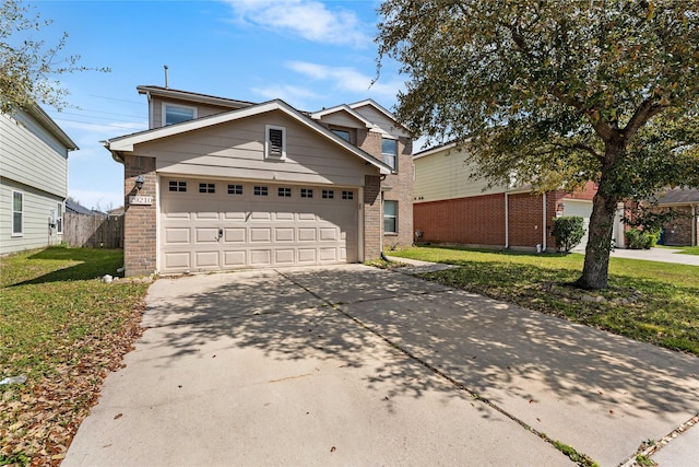 traditional home with a front lawn, fence, concrete driveway, a garage, and brick siding