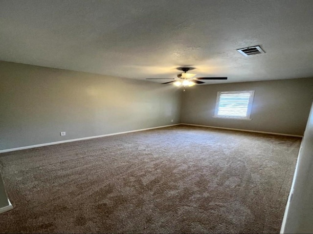 carpeted empty room featuring baseboards, visible vents, a textured ceiling, and a ceiling fan