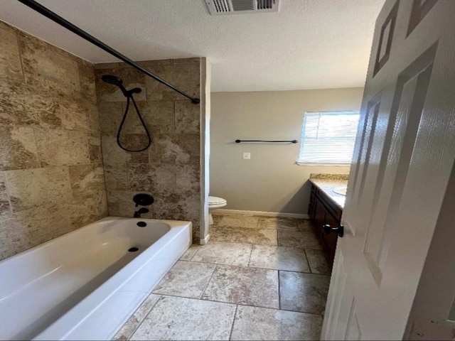 bathroom featuring visible vents, baseboards, toilet, vanity, and a textured ceiling