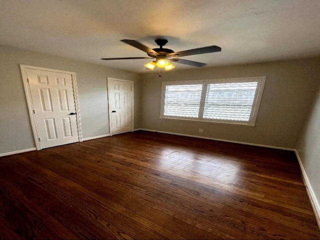 unfurnished bedroom featuring ceiling fan, baseboards, and wood finished floors