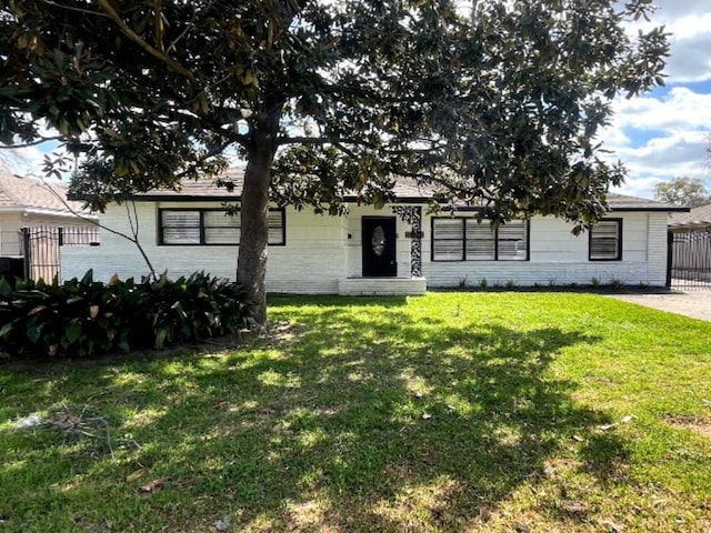 view of front of house with a front lawn and fence