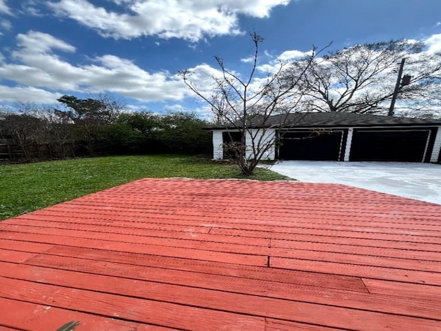 deck with an outbuilding, a yard, and a garage